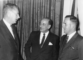 Unidentified men talking indoors, in Belleville, Ontario.