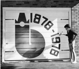 Centennial logs on a garage door