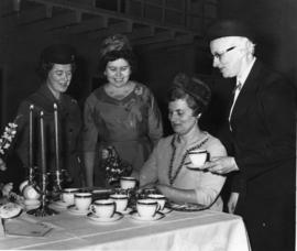 Charlotte Kurlter pouring tea for a group of women in Belleville, Ontario.