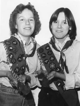 Two girls showing their blue Badge Sash, in Belleville, Ontario.