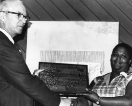 Unidentified man and woman with a thank you Plaque that says "Thank You From Grenada", ...