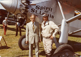 Two men standing in front of plane Spirit of St. Louis