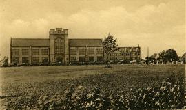 A postcard of the new Albert College, Belleville, Ontario, with a line of cars outside.